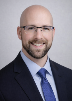 Headshot of Adam Kelly.