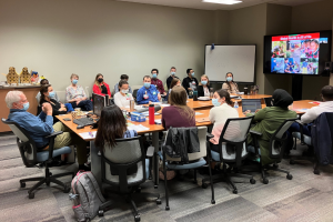Group meeting around a large conference table.