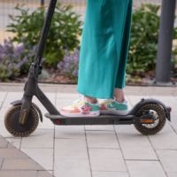 A girl rides an e-scooter.